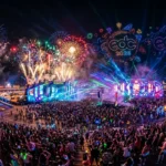 A vibrant night view of the Electric Daisy Carnival 2026 in Las Vegas featuring fireworks and neon stages.