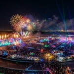Aerial view of the Electric Daisy Carnival festival with colorful lights and fireworks in Las Vegas.